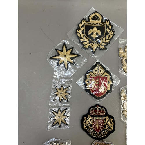 260 - A collection of embroidered uniform insignias