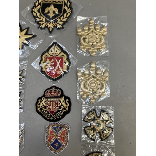 260 - A collection of embroidered uniform insignias