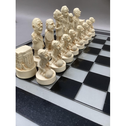 112 - Chess figures formed as characters from the Watergate Nixon scandal, with glass chess board