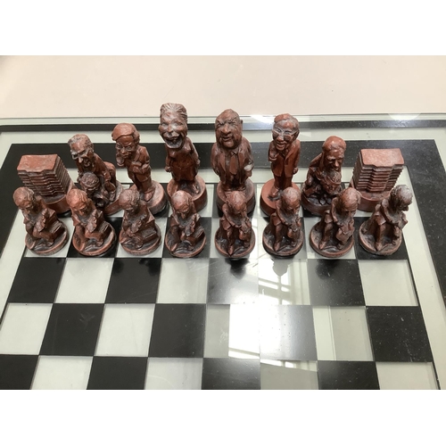 112 - Chess figures formed as characters from the Watergate Nixon scandal, with glass chess board