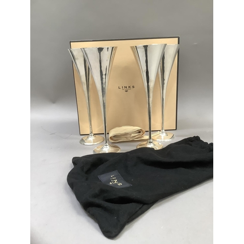 69 - A Links London set of four silver plated champagne flutes, in individual cloth bags, boxed