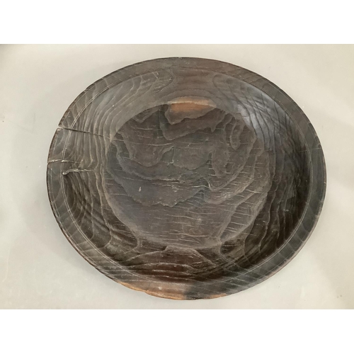 72 - A primitive heavily grained fruitwood bowl, of shallow form, 43cm diameter