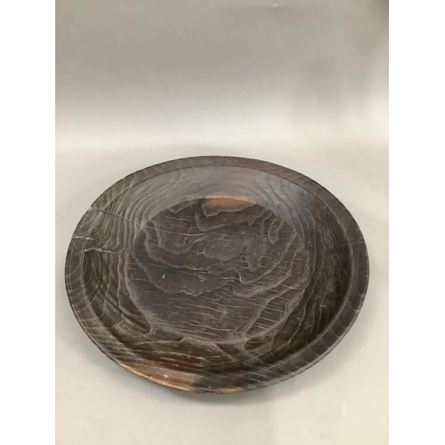 72 - A primitive heavily grained fruitwood bowl, of shallow form, 43cm diameter