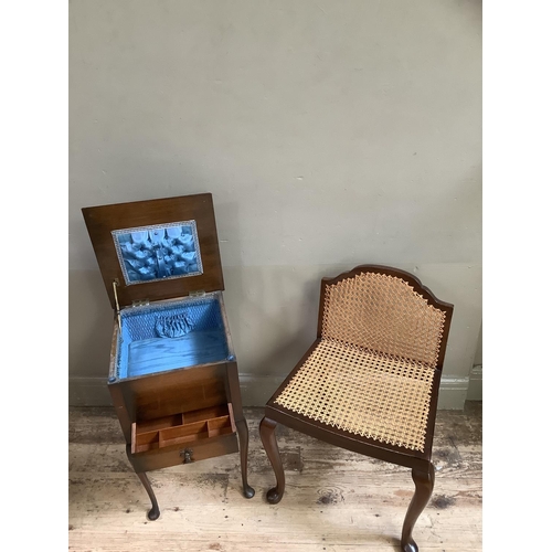 132 - A cane seated mahogany bedroom chair together with a mahogany sewing box with single drawer on cabri... 