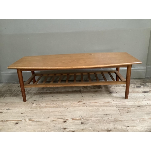 140 - A mid century teak coffee table with rack under tier, 120cm x 54cm