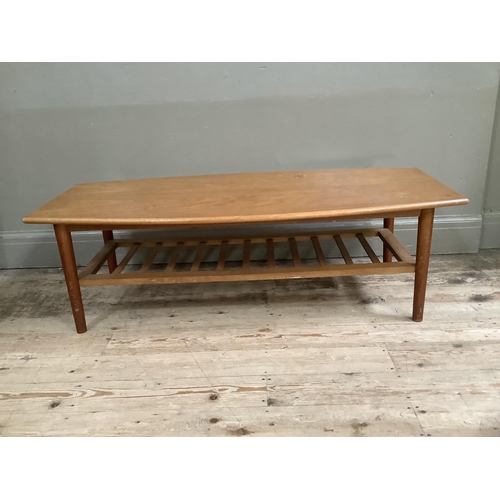 140 - A mid century teak coffee table with rack under tier, 120cm x 54cm