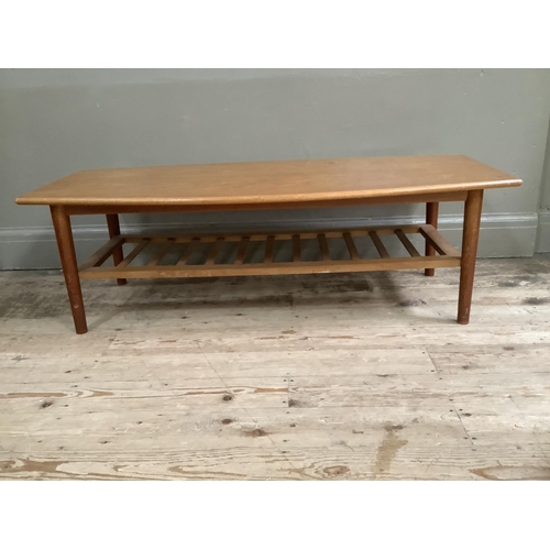 140 - A mid century teak coffee table with rack under tier, 120cm x 54cm