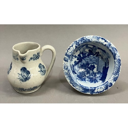 23 - A 19th Century pottery cream jug stencilled in blue with a repeat pattern of a flowering plant in a ... 