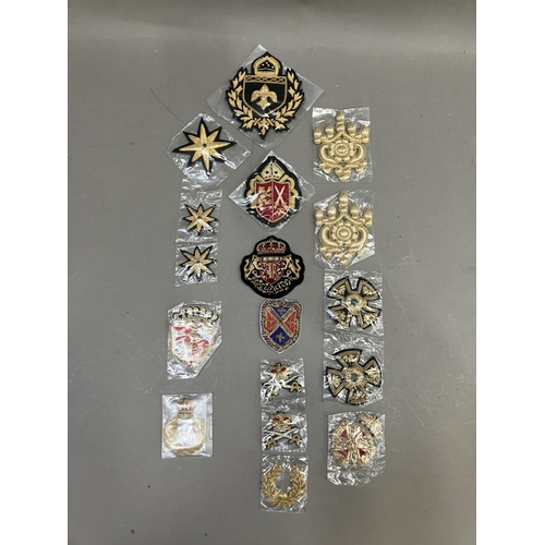 260 - A collection of embroidered uniform insignias