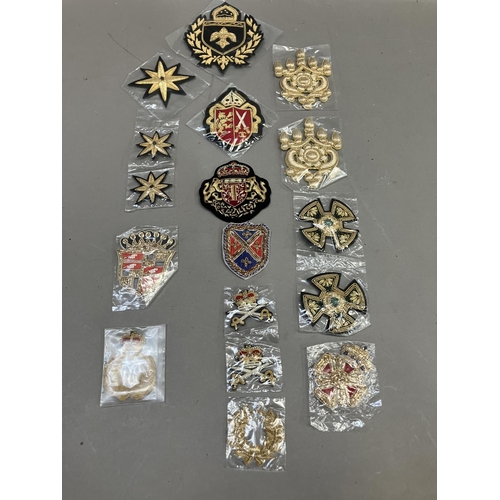 260 - A collection of embroidered uniform insignias