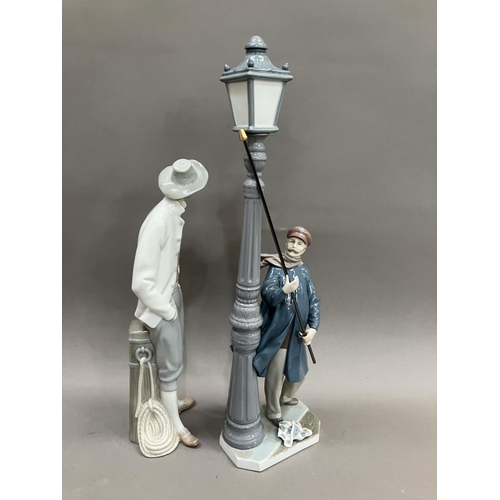 75 - A Lladro figure of a Lamplighter, no.5205 48cm high and a figure of a Sailor no.4657