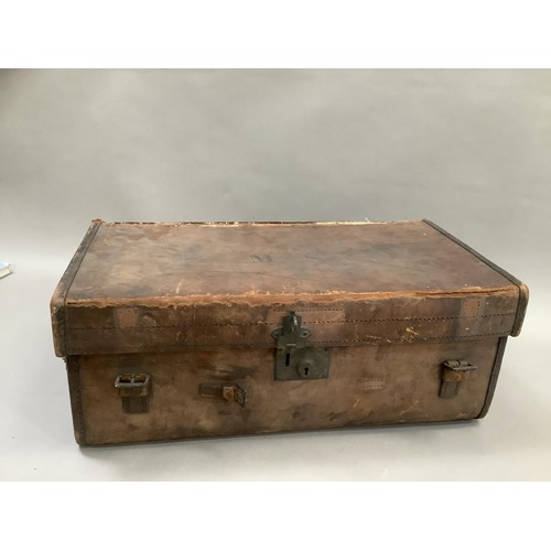 153 - A leather monogrammed travel trunk with two handles, M. S. to the top