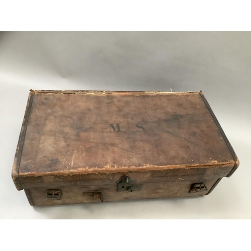 153 - A leather monogrammed travel trunk with two handles, M. S. to the top