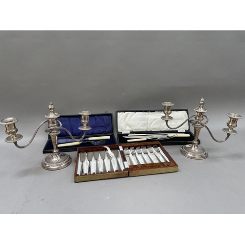 200 - A pair of EPNS candelabras, a cased set of ivorine fish servers, together with two further set of ca... 