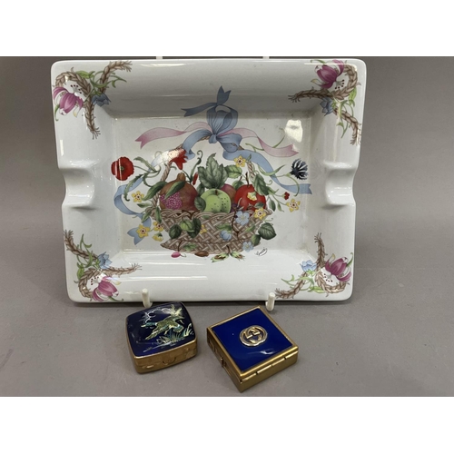 77 - A Gucci x Mancioli ashtray, painted with a fruit basket and flowers together with a blue enamelled p... 