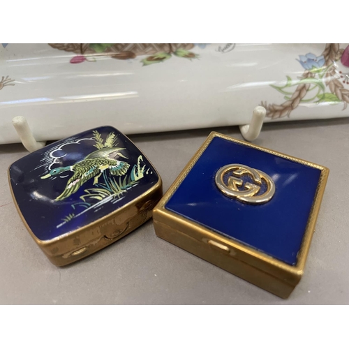 77 - A Gucci x Mancioli ashtray, painted with a fruit basket and flowers together with a blue enamelled p... 