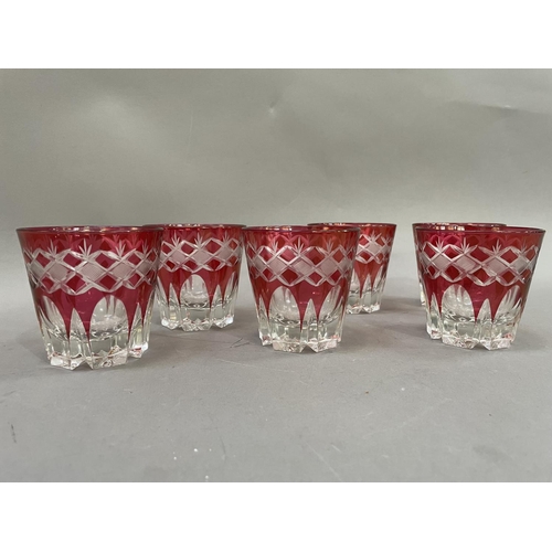 79 - A suite of six Bohemian cut glass cranberry tumblers