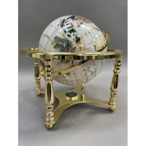 81 - A specimen globe on gilt metal mounts with built in compass to base, 28cm high