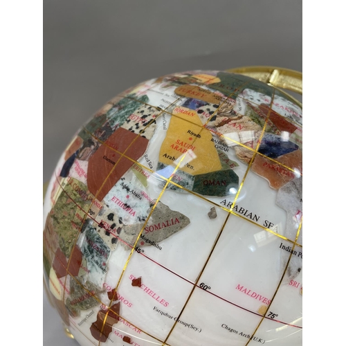 81 - A specimen globe on gilt metal mounts with built in compass to base, 28cm high