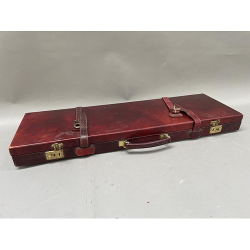 313 - A shotgun case in oxblood leather with red corduroy fitted interior, suitable for a 30