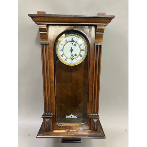 327 - A late 19th Century walnut and ebony wall clock, in a three light case, missing pendulum, approximat... 