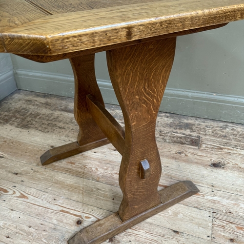 352 - A small oak refectory table on shaped standards joined by a stretcher, 70cm x 64cm x 70cm