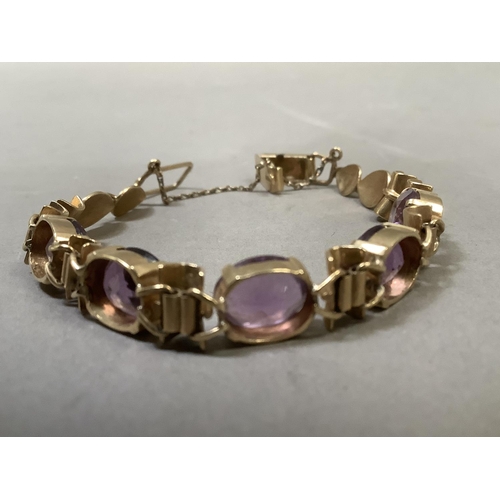 281 - An Amethyst bracelet, the five oval facetted stones claw set to links alternating bamboo style links... 