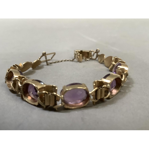 281 - An Amethyst bracelet, the five oval facetted stones claw set to links alternating bamboo style links... 