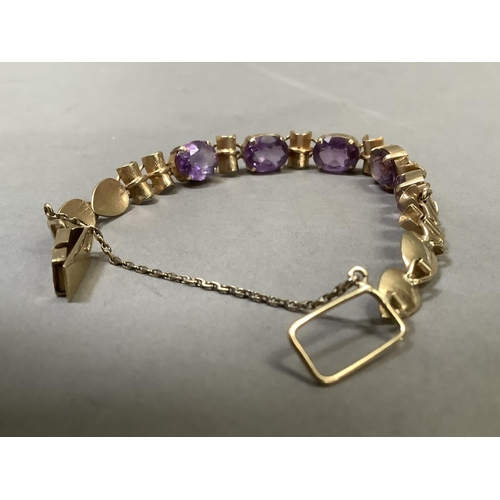 281 - An Amethyst bracelet, the five oval facetted stones claw set to links alternating bamboo style links... 