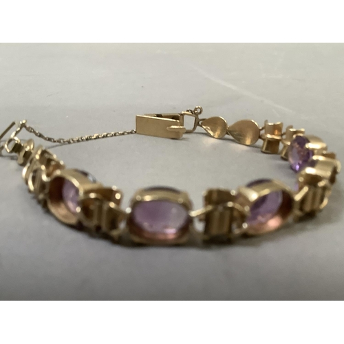 281 - An Amethyst bracelet, the five oval facetted stones claw set to links alternating bamboo style links... 