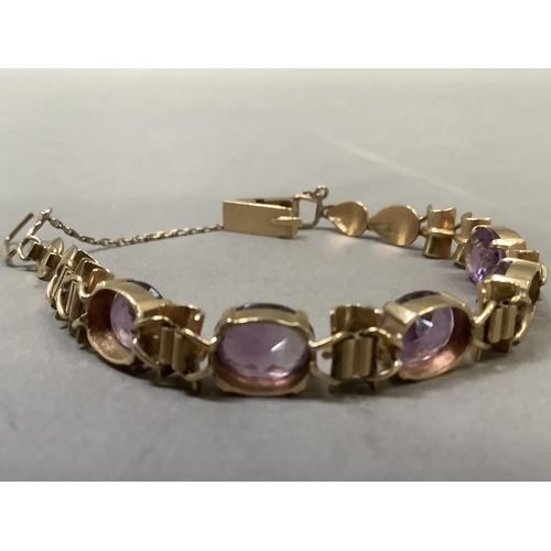 281 - An Amethyst bracelet, the five oval facetted stones claw set to links alternating bamboo style links... 