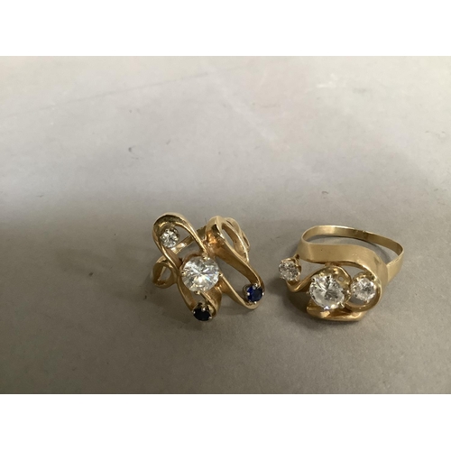 277 - Two dress rings set with cubic zirconia and sapphire, the circular facetted stones claw set within a... 