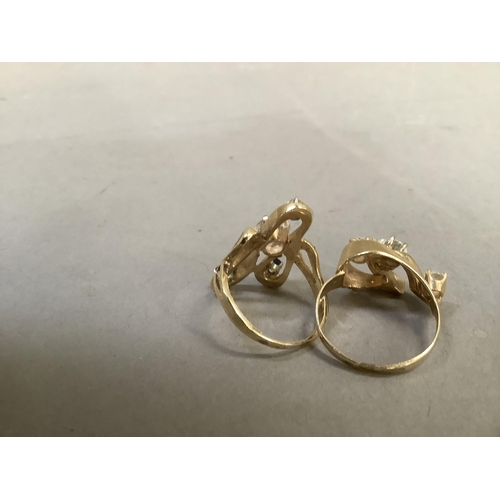 277 - Two dress rings set with cubic zirconia and sapphire, the circular facetted stones claw set within a... 