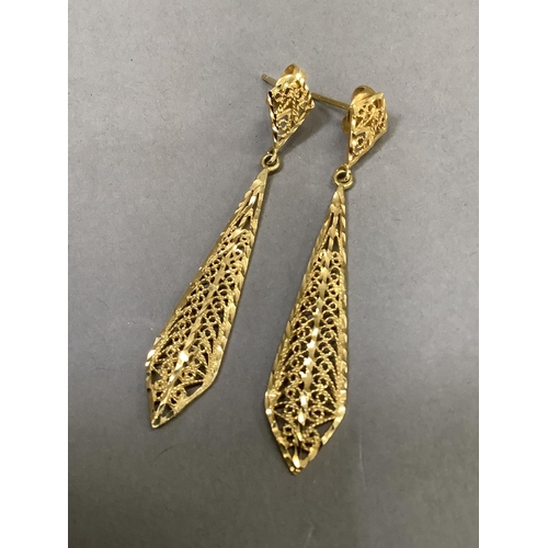 279 - A pair of ear pendants, filigree lozenge drops with post and scroll fittings, in yellow metal (tests... 