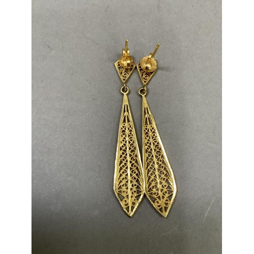 279 - A pair of ear pendants, filigree lozenge drops with post and scroll fittings, in yellow metal (tests... 