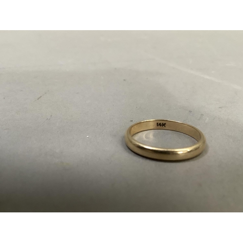 285 - A wedding ring in yellow metal (tests as 14ct gold) finger size 'O', approx. weight 2g