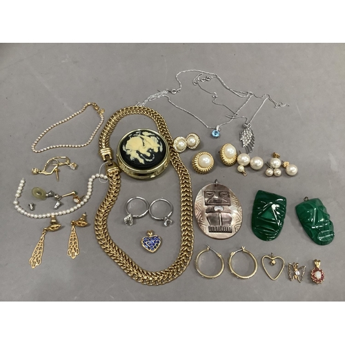 286 - A small collection of costume jewellery with two malachite carved masks, oval abalone shell pendant ... 