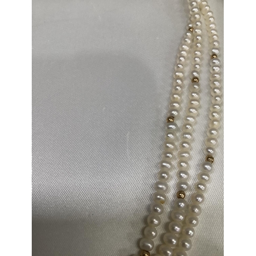 294 - A fresh water cultured pearl necklace of three  rows 4.5mm, pearls interspersed with small circular ... 