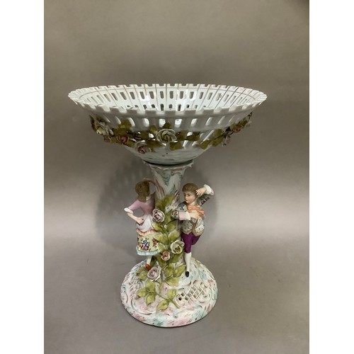 98 - A continental porcelain pedestal dish, the bowl formed as a flower encrusted pierced basket, the sup... 