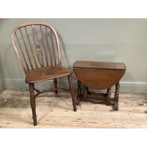 321 - An oak drop leaf gate legged occasional table and an elm kitchen chair