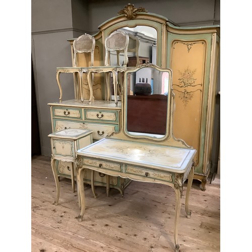 300 - A continental style, oak-lined painted and gilt bedroom suite comprising a triple mirrored wardrobe ... 