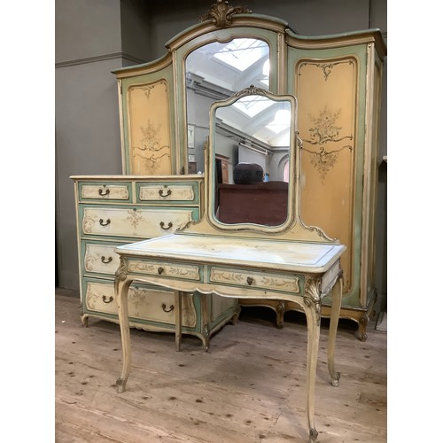 300 - A continental style, oak-lined painted and gilt bedroom suite comprising a triple mirrored wardrobe ... 