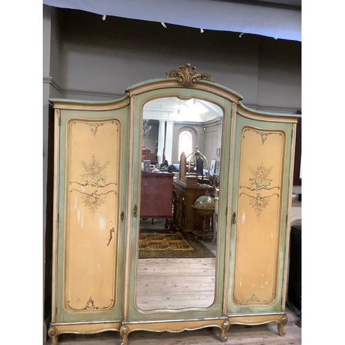 300 - A continental style, oak-lined painted and gilt bedroom suite comprising a triple mirrored wardrobe ... 