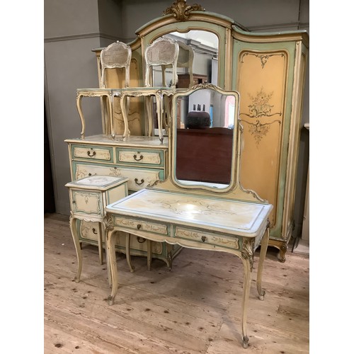 300 - A continental style, oak-lined painted and gilt bedroom suite comprising a triple mirrored wardrobe ... 