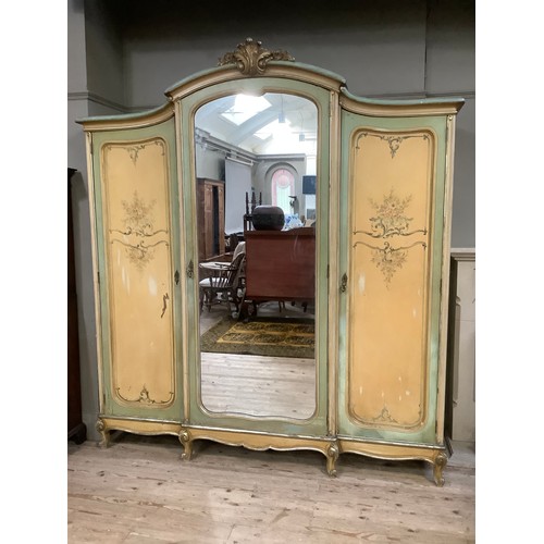 300 - A continental style, oak-lined painted and gilt bedroom suite comprising a triple mirrored wardrobe ... 