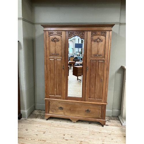 296 - An Edwardian walnut double wardrobe with central mirrored door, having a moulded cornice with Art No... 