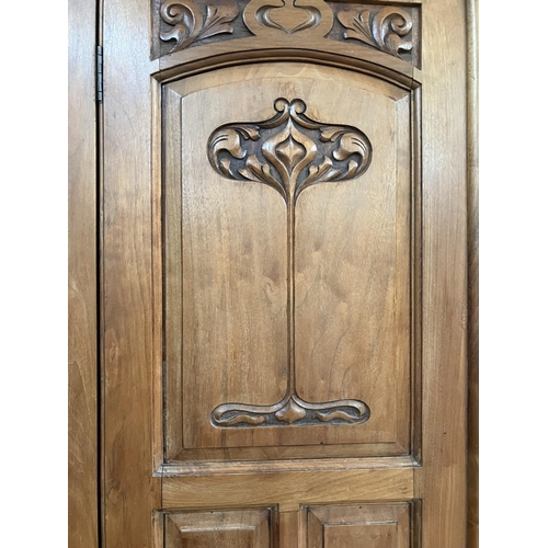 296 - An Edwardian walnut double wardrobe with central mirrored door, having a moulded cornice with Art No... 