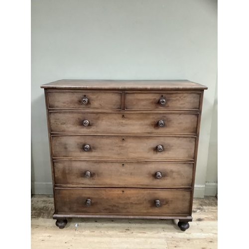 301 - A Victorian mahogany chest of two short above four long drawers with turned wooden handles on bun fe... 