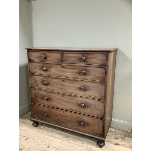 301 - A Victorian mahogany chest of two short above four long drawers with turned wooden handles on bun fe... 