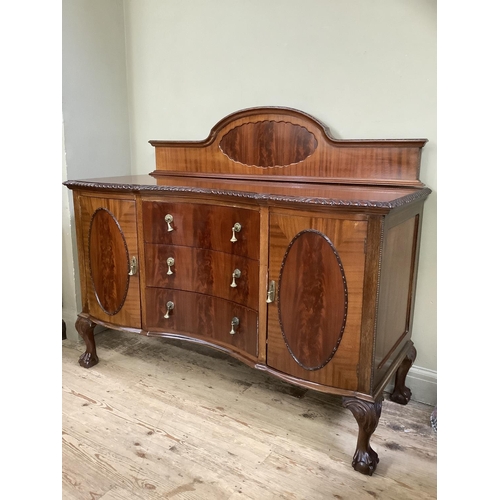 341 - A mahogany sideboard with semi-arched raised back, gadroon rim over three concave drawers flanked by... 